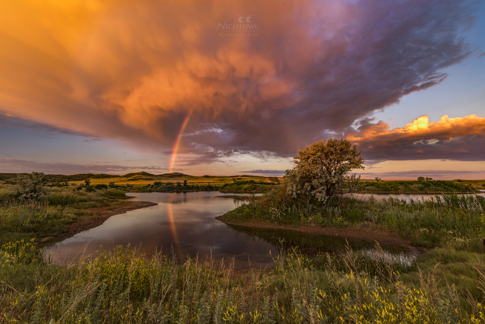 A rainbow beneath an evening storm