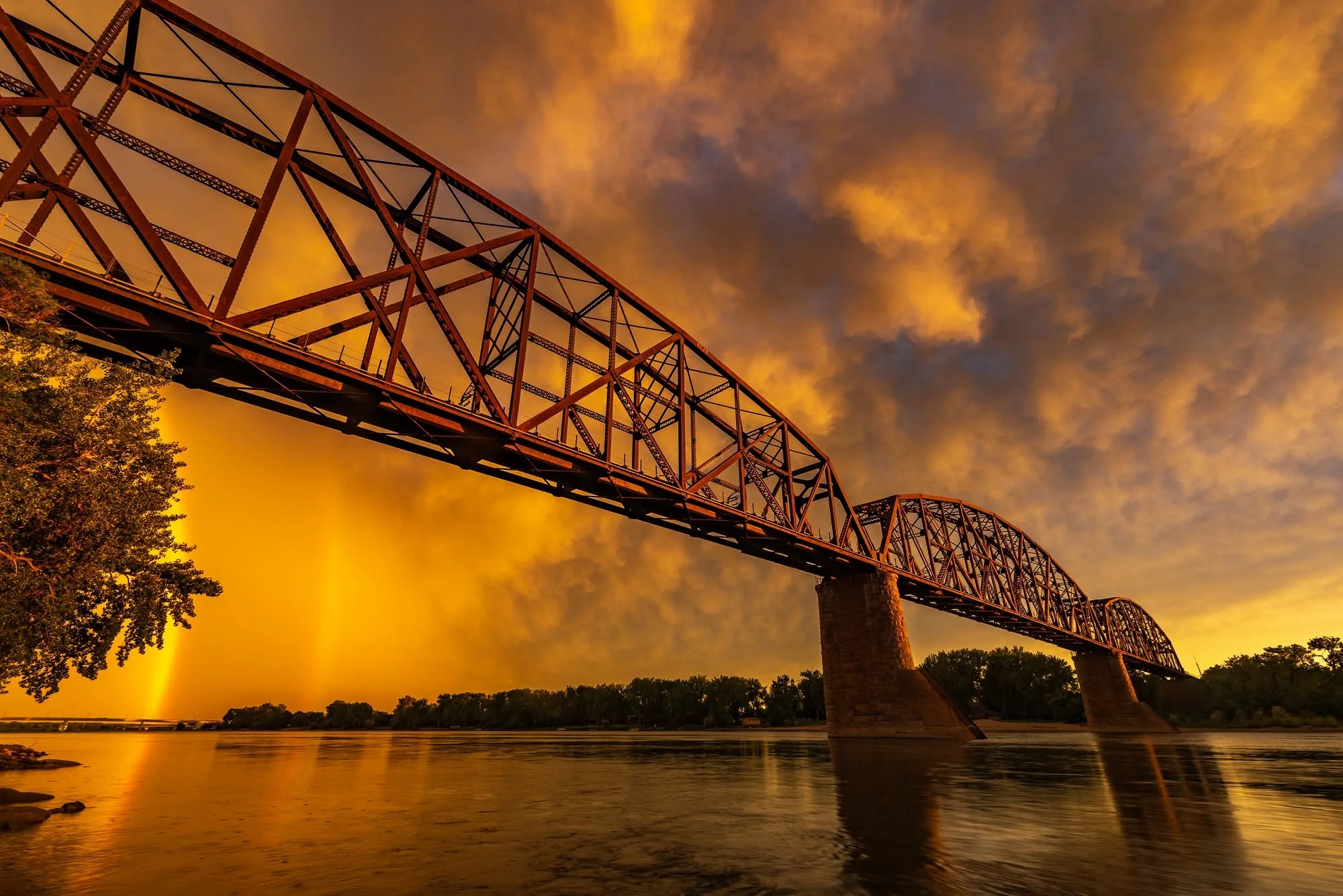 Golden clouds behind the steel arches