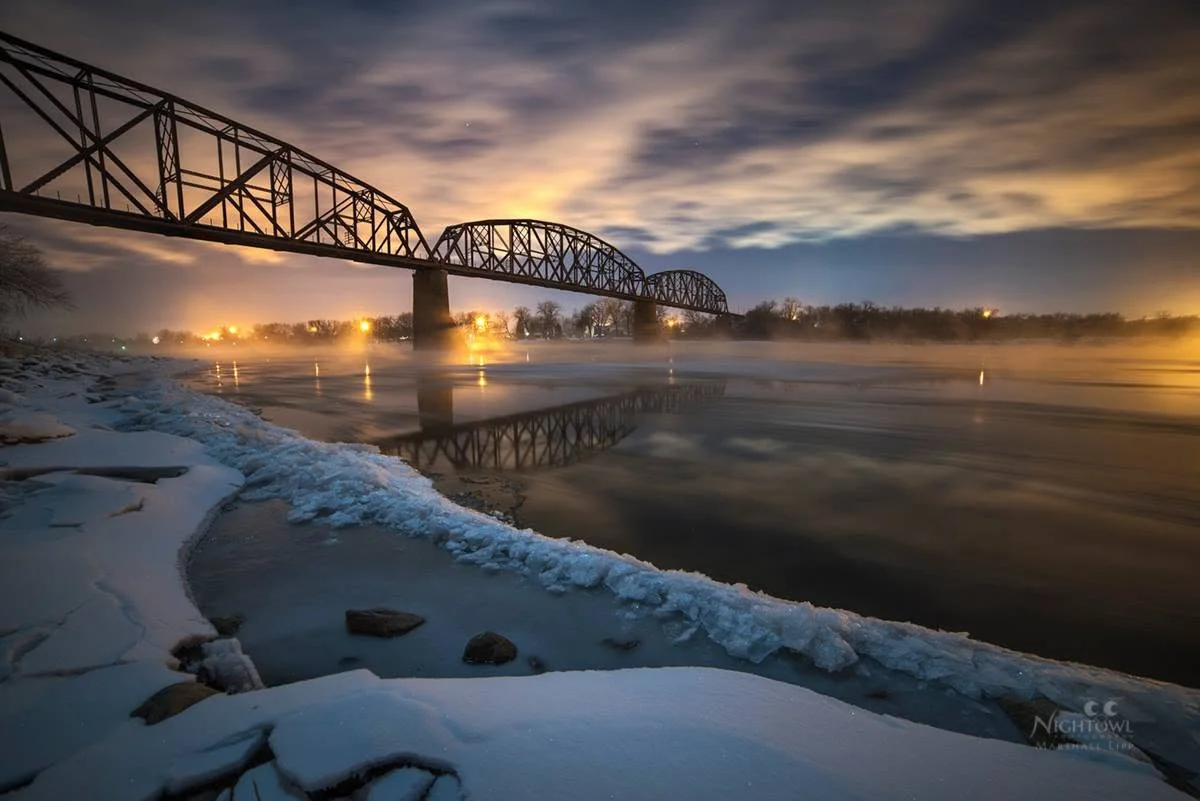 River ice beneath a clouded night sky